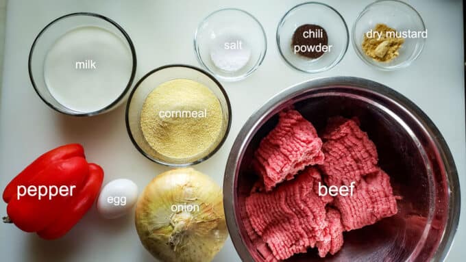 Ingredients for meatballs; beef, onion, pepper, egg, milk, cornmeal, chili powder, dry mustard.