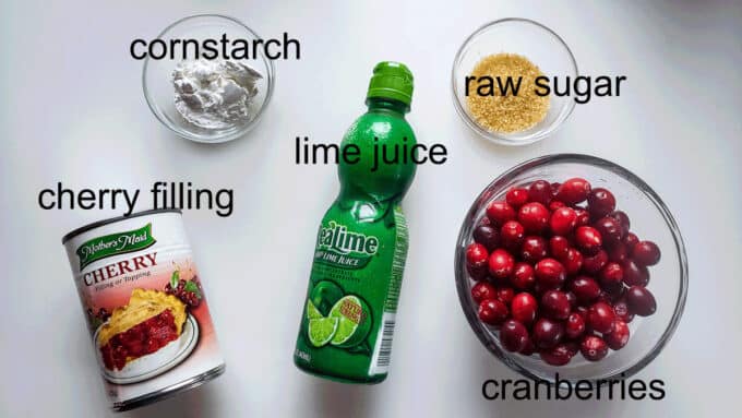 Ingredients for filling cherry pie filling, cornstarch, lime juice, raw sugar, cranberries.