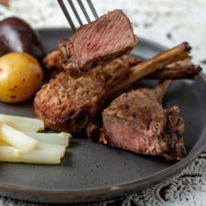 Close up photo of cut lamb chop on fork