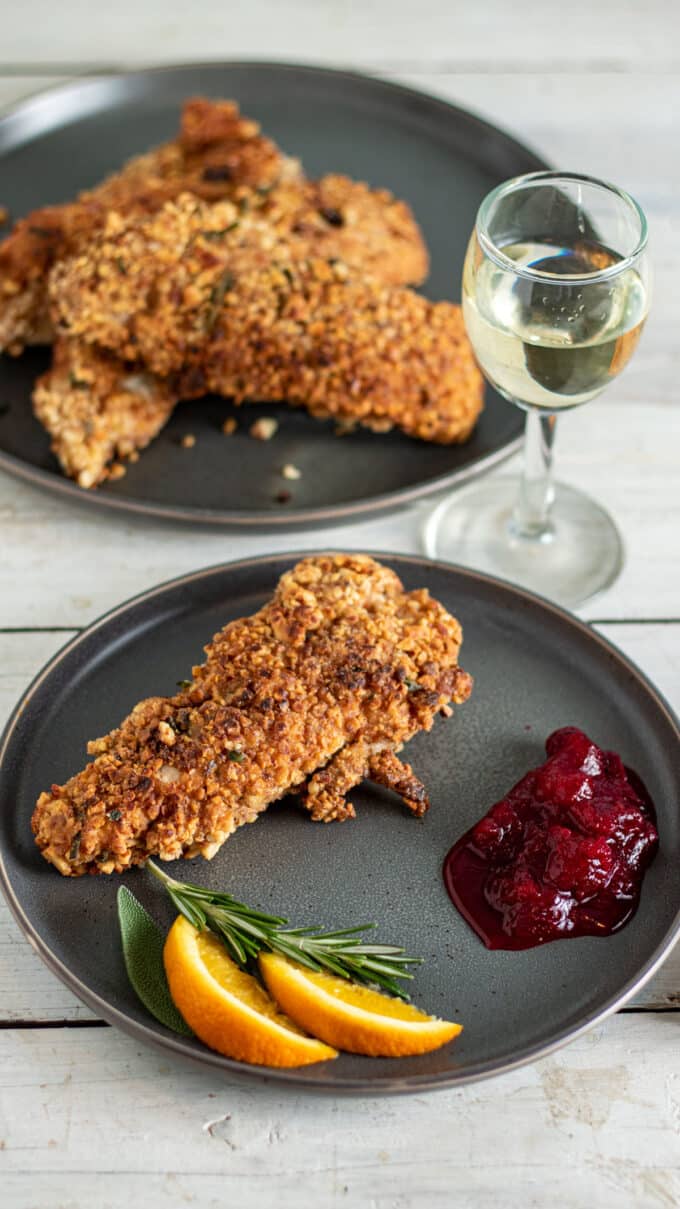 Crispy crusted turkey on grey plate with sides.