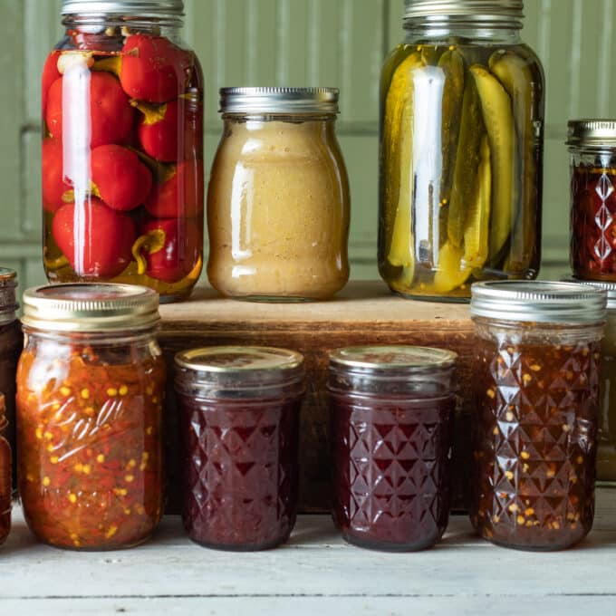 Colorful jars of canned vegetables and fruits.