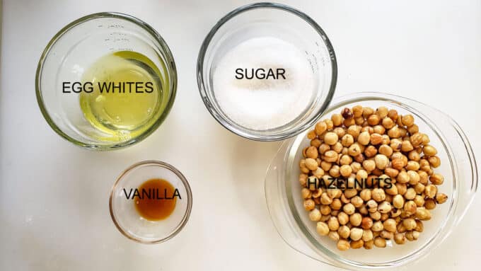 Ingredients used in cookies. Egg whites, sugar, vanilla and hazelnuts.