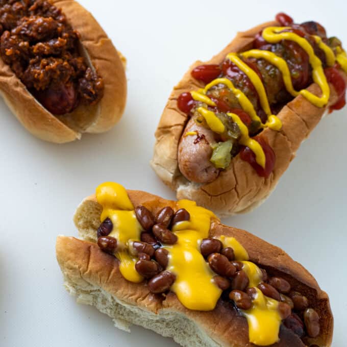 Air fried hot dogs with different toppings.