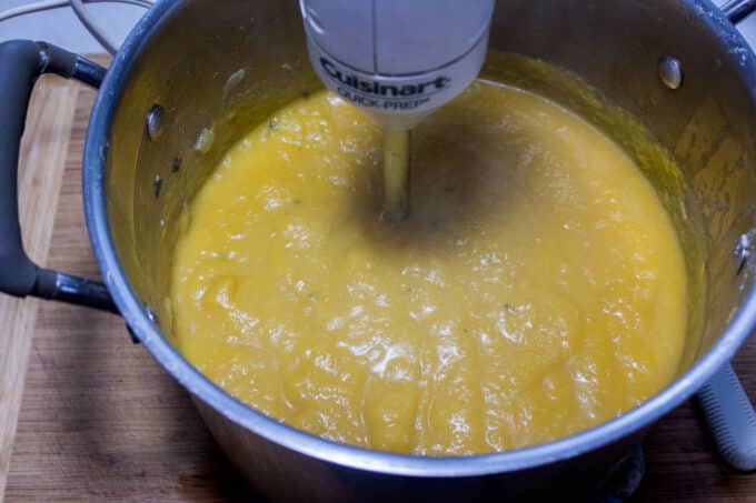 Pureeing soup to blend.