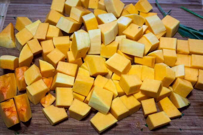 Chopped butternut squash on board.