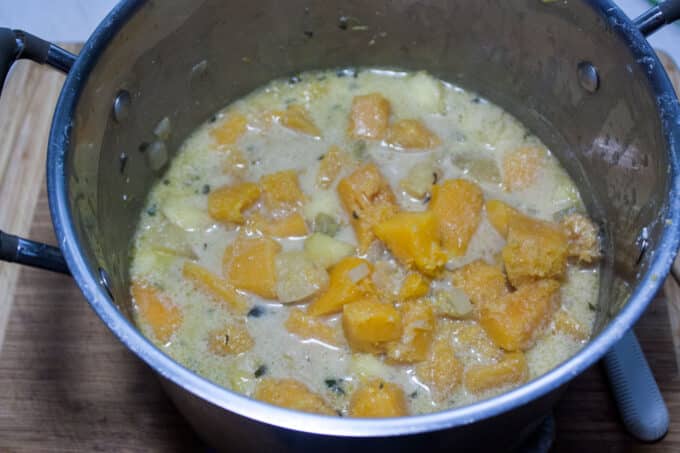 Cooked down vegetables in pot.