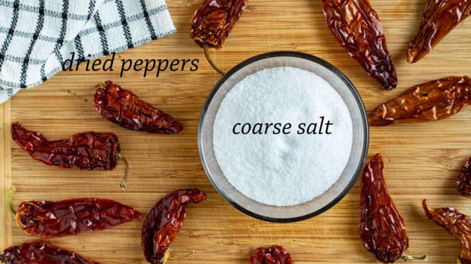 ingredients; salt and dried peppers on wooden board.