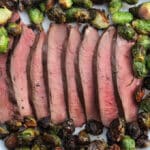 Sliced deer heart with brussels sprouts.