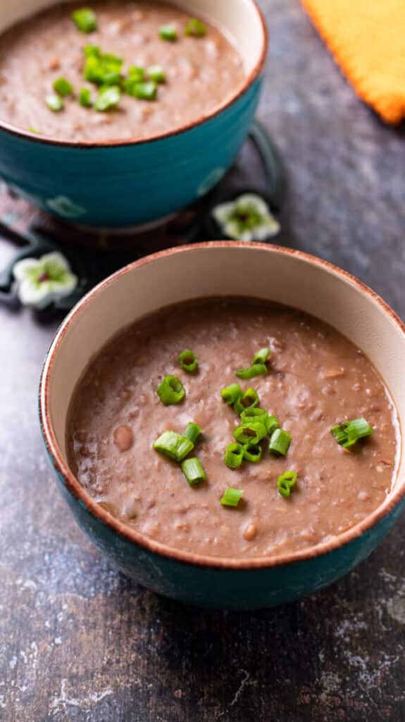 Bowls filled with mashed beans. Refried beans style.
