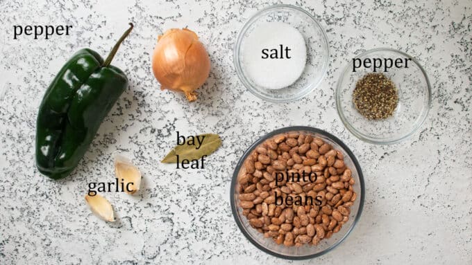 Ingredients for beans. Pinto beans, garlic, bay leaf, pepper, onion, salt, pepper.