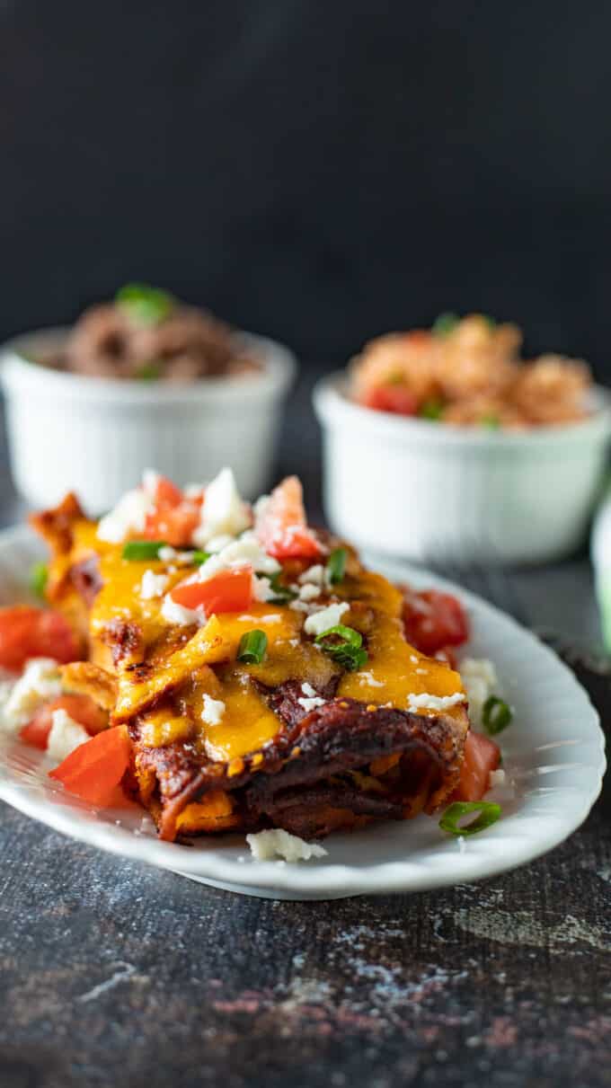 Two enchiladas with rice and beans.