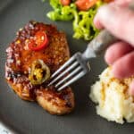 Fork stabbing pork chop.