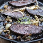 Deer liver and onions in a cast pan.