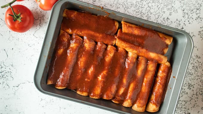 Assembled enchiladas in baking tray before baking..
