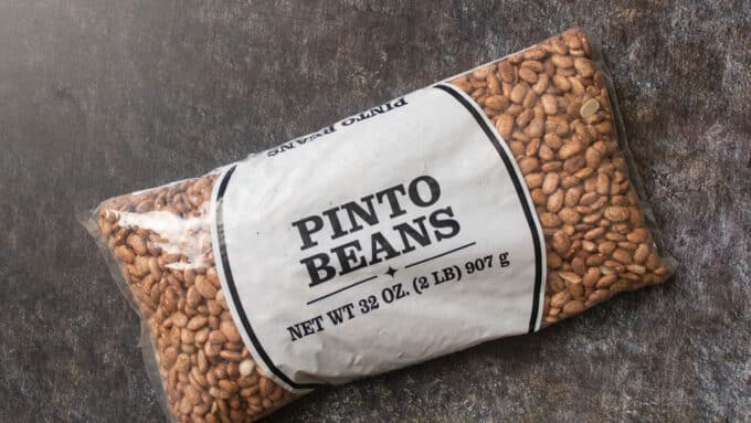 Bag of Pinto beans on gray background.