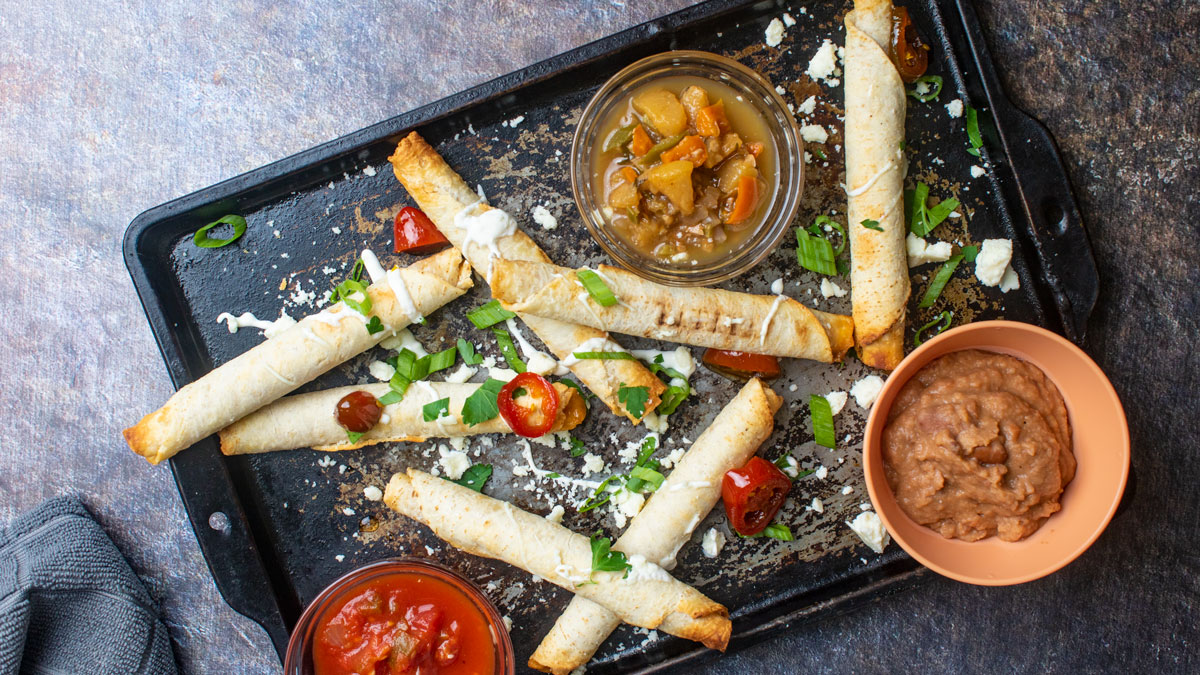 Taquitos with refried beans and two salsas.