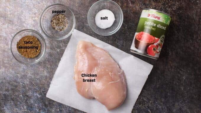 Ingredients for tacos; chicken, tomatoes, taco seasoning, salt and pepper.
