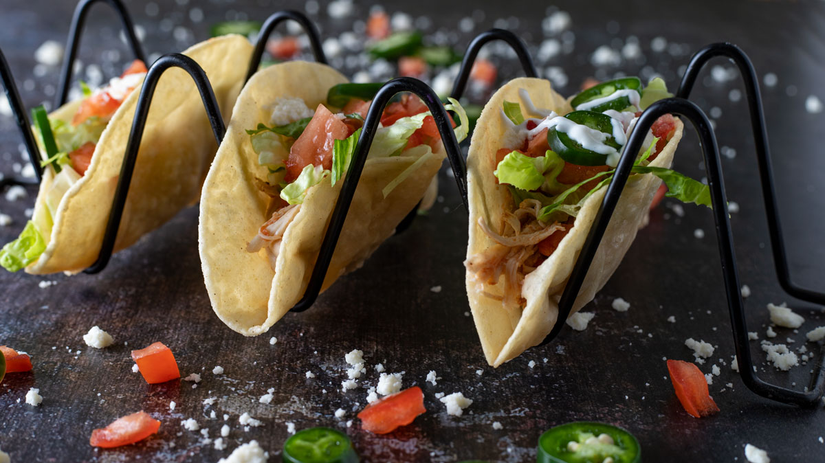 Three tacos in taco holder.