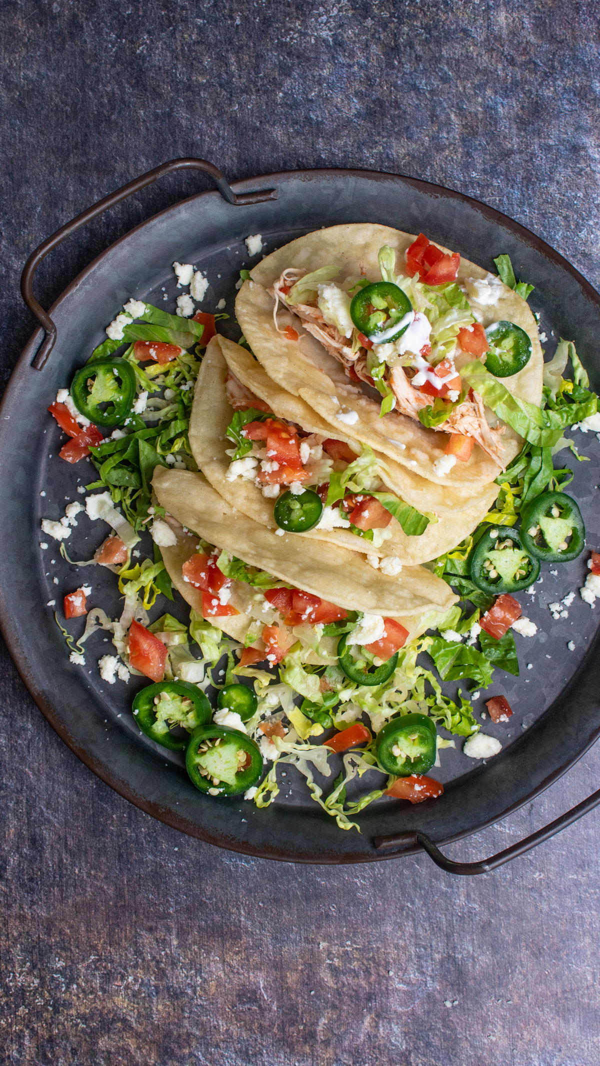 Overhead photo of tacos on metal tray.