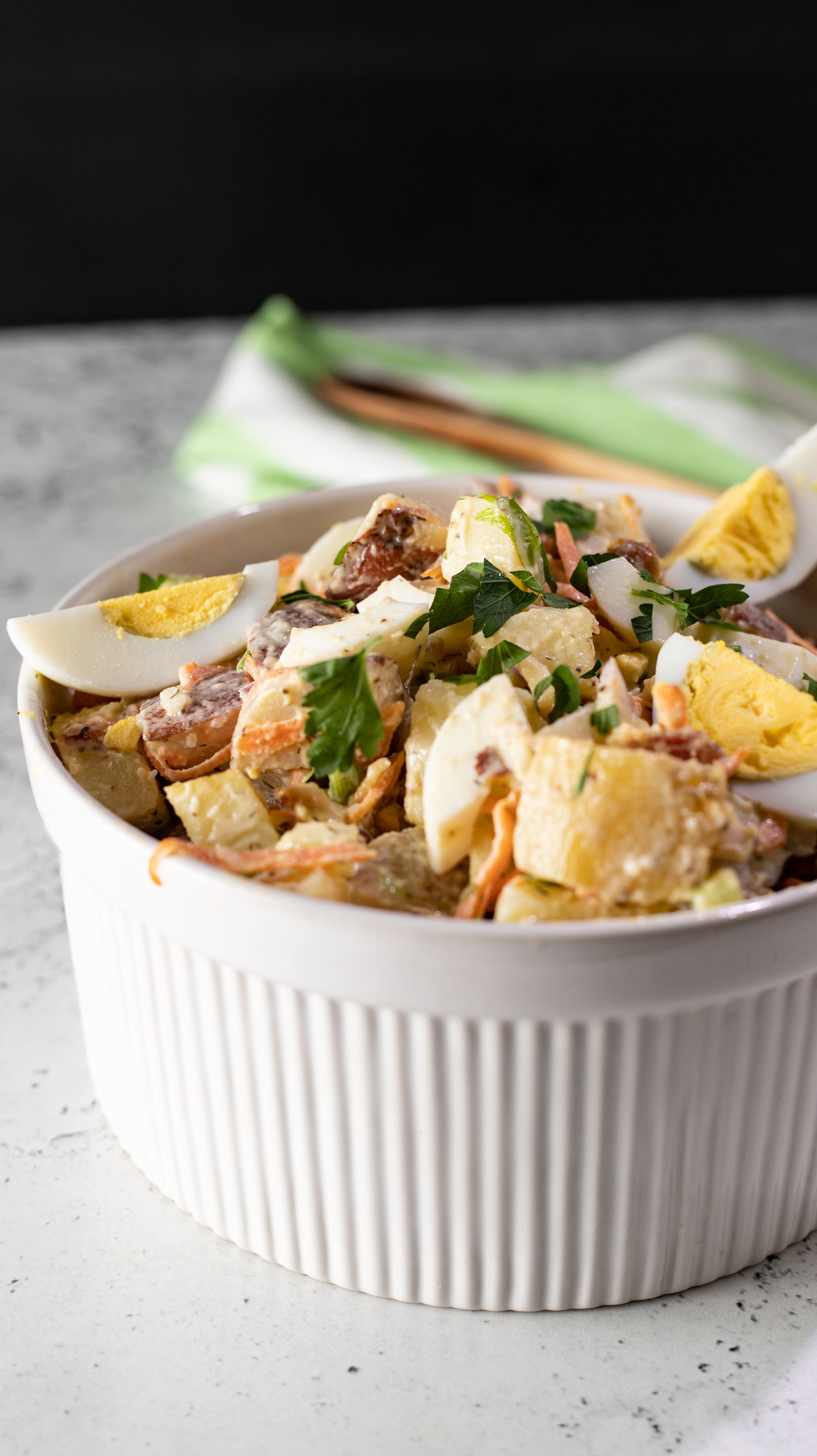 Crunchy, creamy potato salad with bacon bits and hard boiled egg.