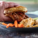 Hand grabbing sloppy joe sandwivh.