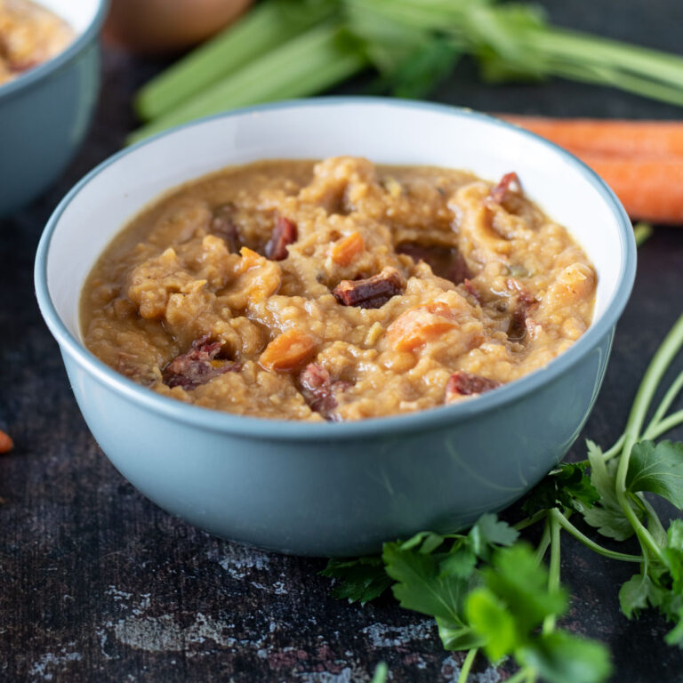 Blue bowl with yellow split pea soup.