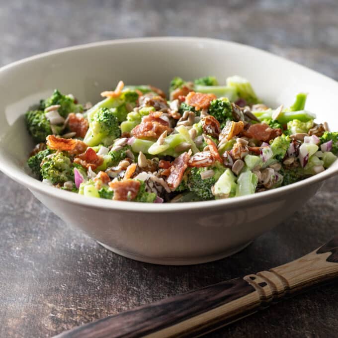 White bowl filled with broccoli salad.