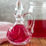 Chive blossom vinegar in antique cruet.