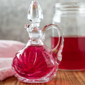 Chive blossom vinegar in antique cruet.