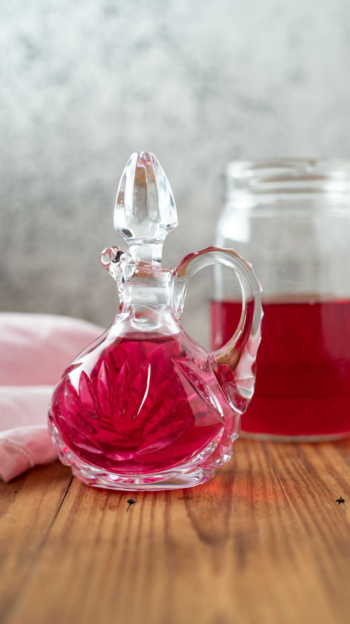 Cruet with jar of chive blossom vinegar.