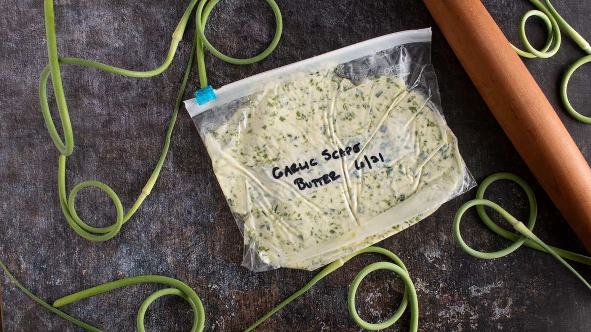 Bag of garlic scape butter with rolling pin.
