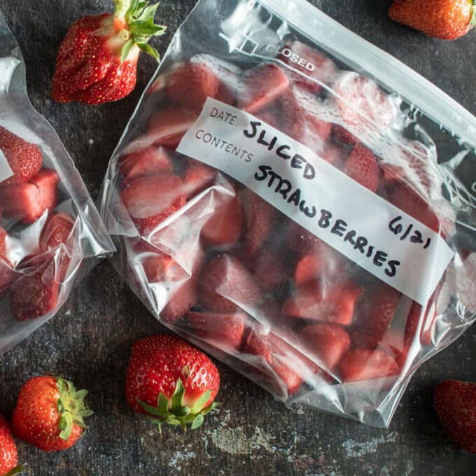 Freezer bags filled with sliced strawberries.