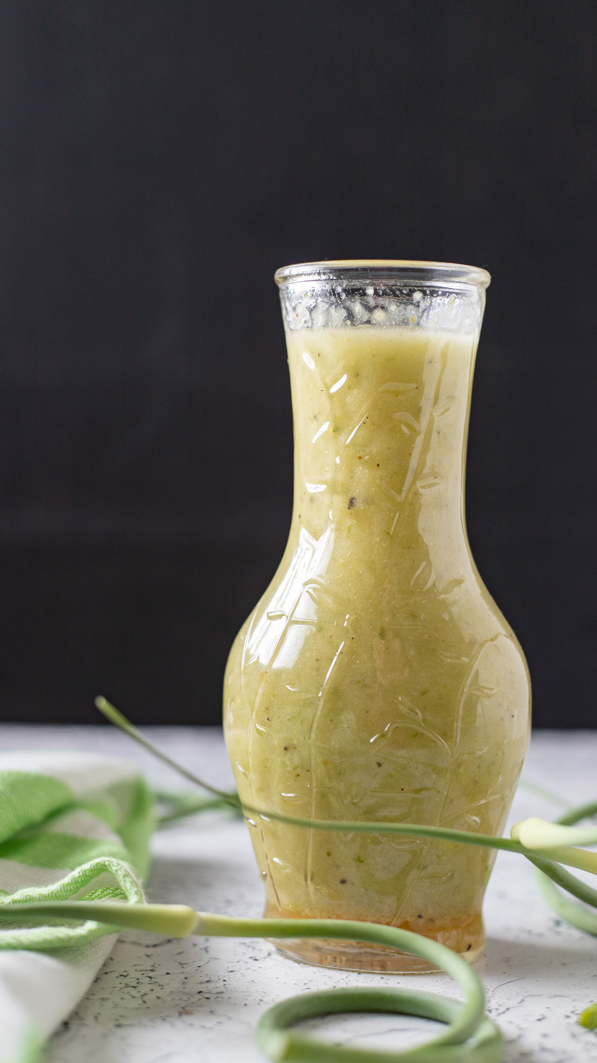 Cruet filled with garlic scape vinaigrette.