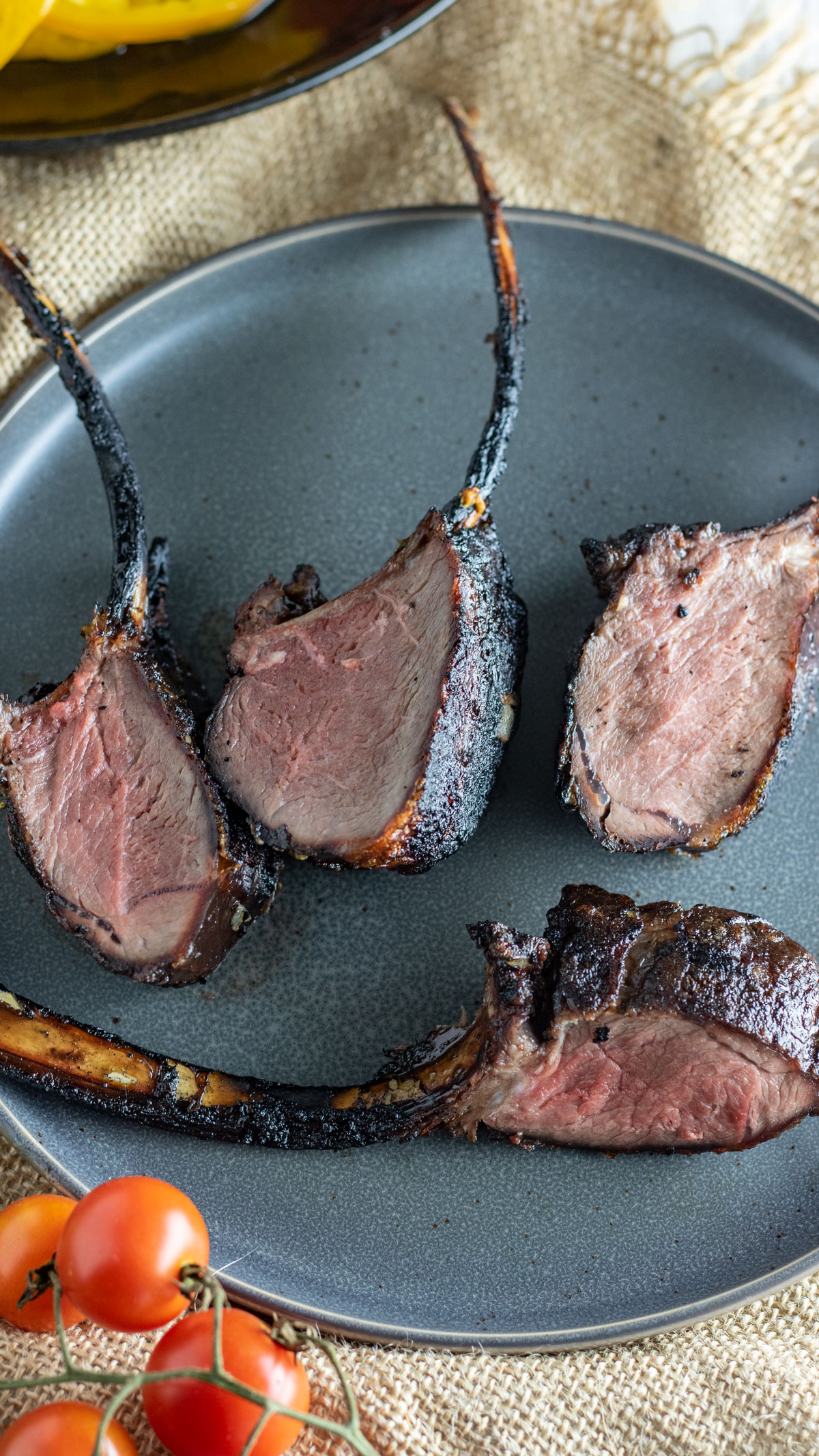 Venison backstrap with rib bone attached on gray plate.