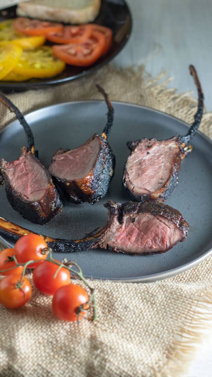 4 venison rib steaks on gray plate.