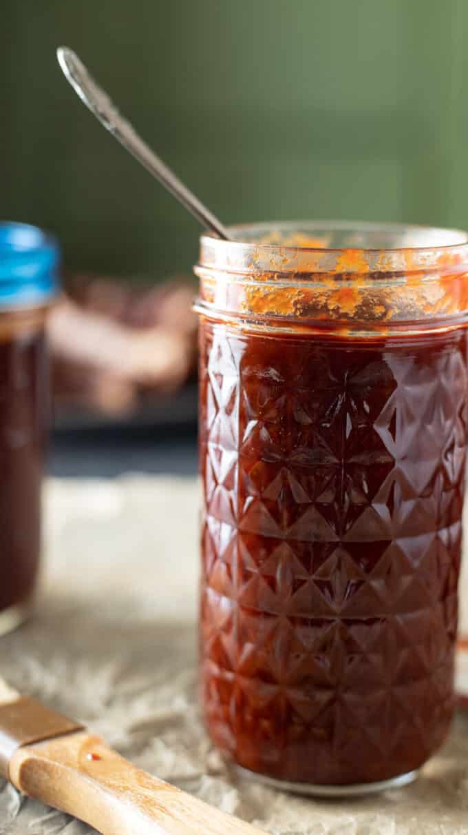 Spoon resting in jar of sauce.