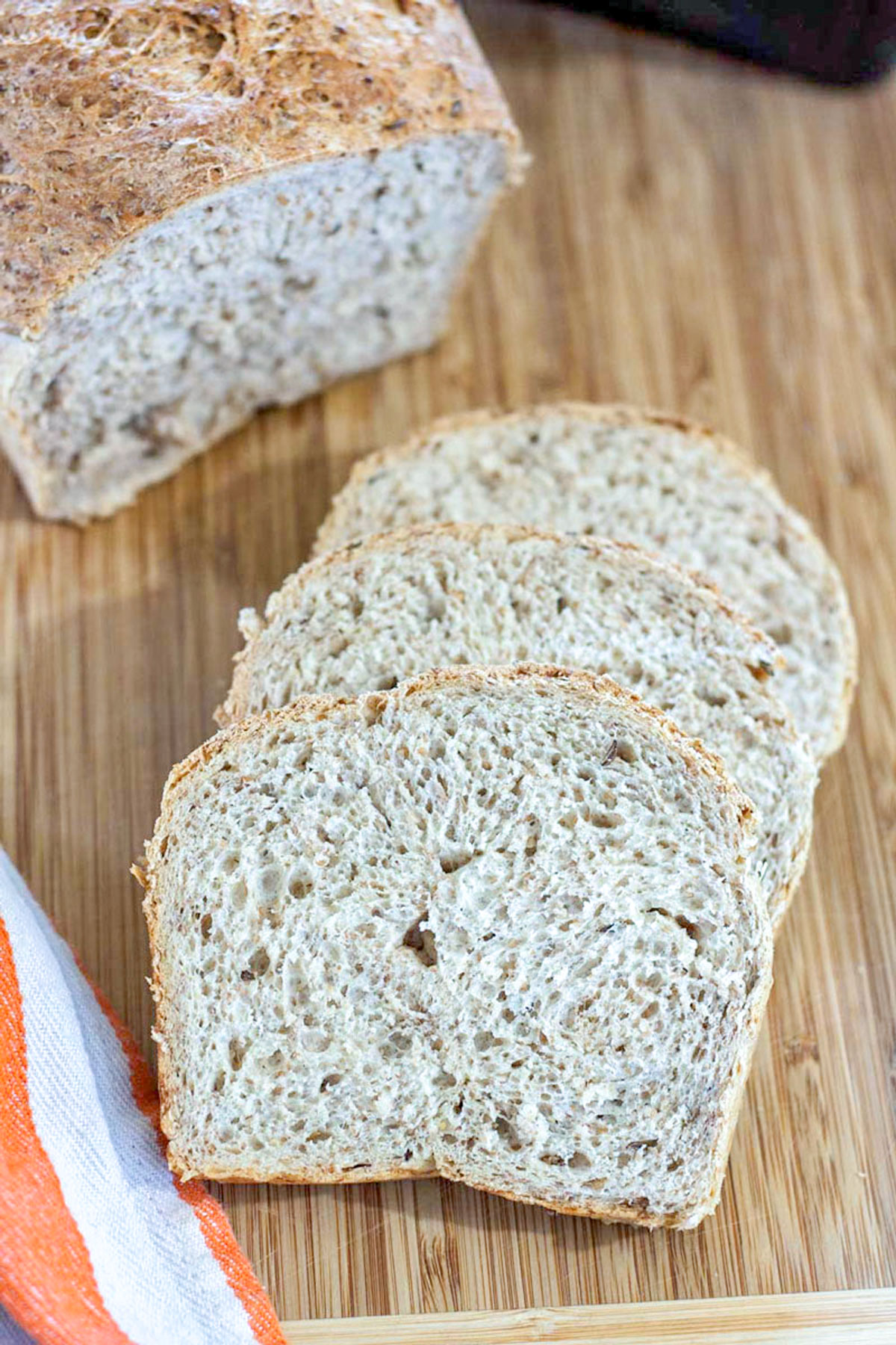 Slices of rye bread on wooden cutting board