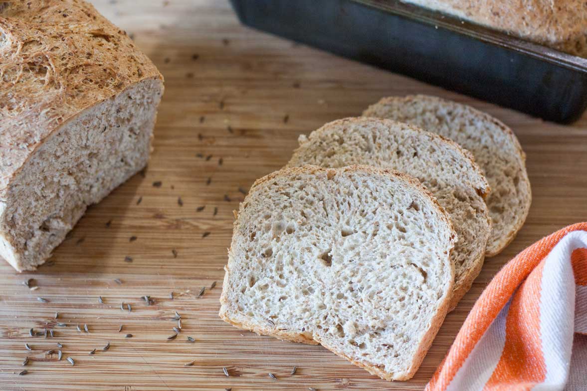 3 slices rye bread on bamboo cutting board