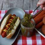 garlic scape relish in jar with spoon scooping some out.
