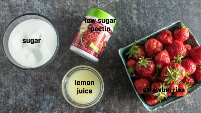 Ingredients for jam strawberries, pectin, sugar, lemon juice.