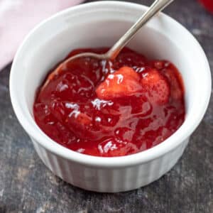 Small white bowl with strawberry pie filling.