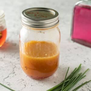 Chive vinaigrette in canning jar.