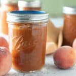 Close up of jars of peach bourbon BBQ sauce.
