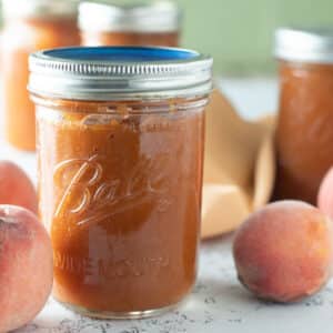 Close up of jars of peach bourbon BBQ sauce.