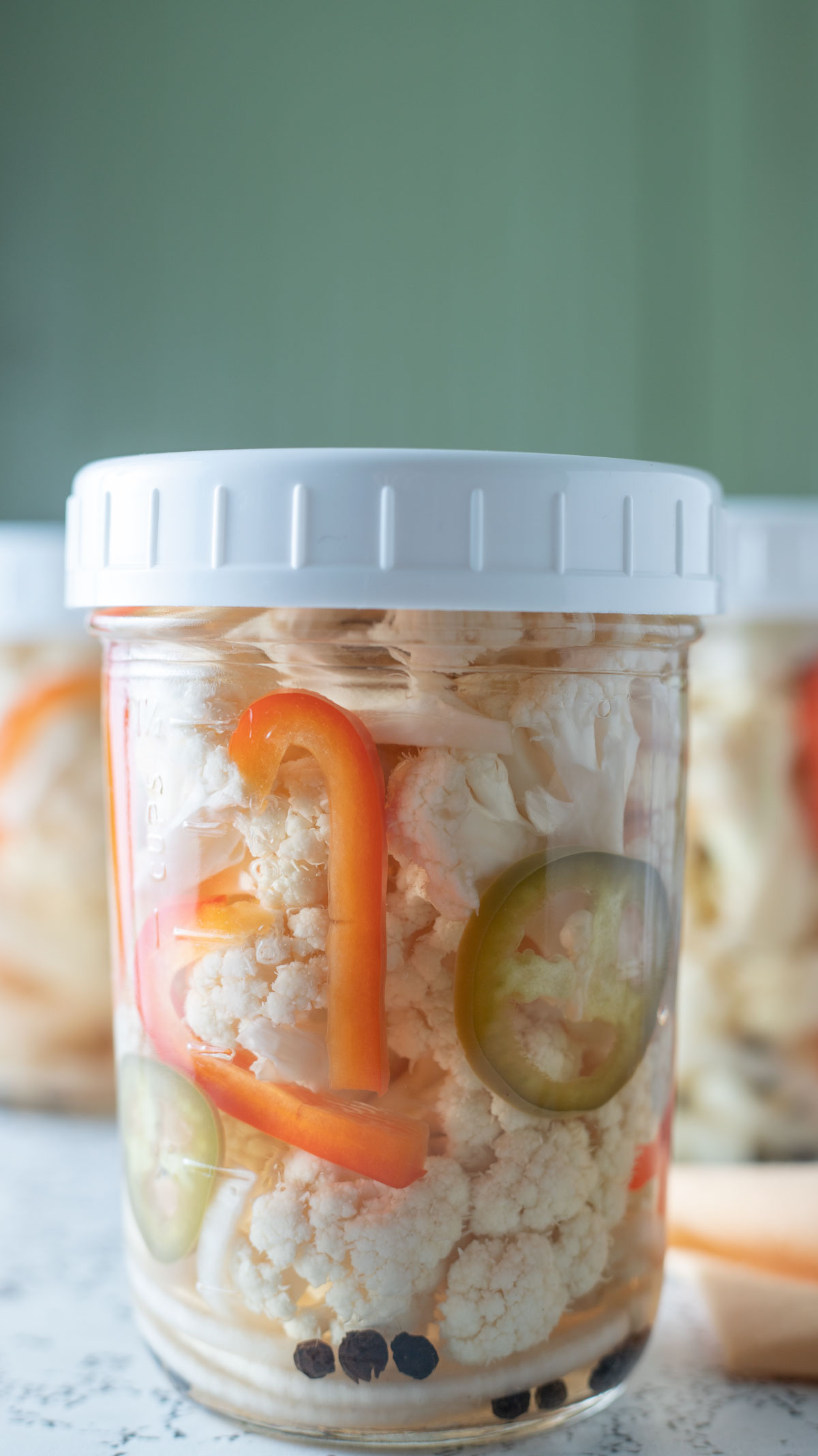 Close up photo of jars on white board.