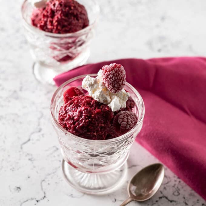 Two dessert bowls with raspberry sherbet.