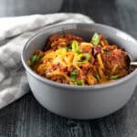 Bowl of chili with toppings.