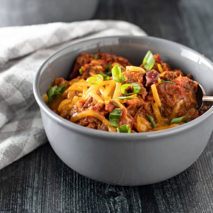 Bowl of chili with toppings.