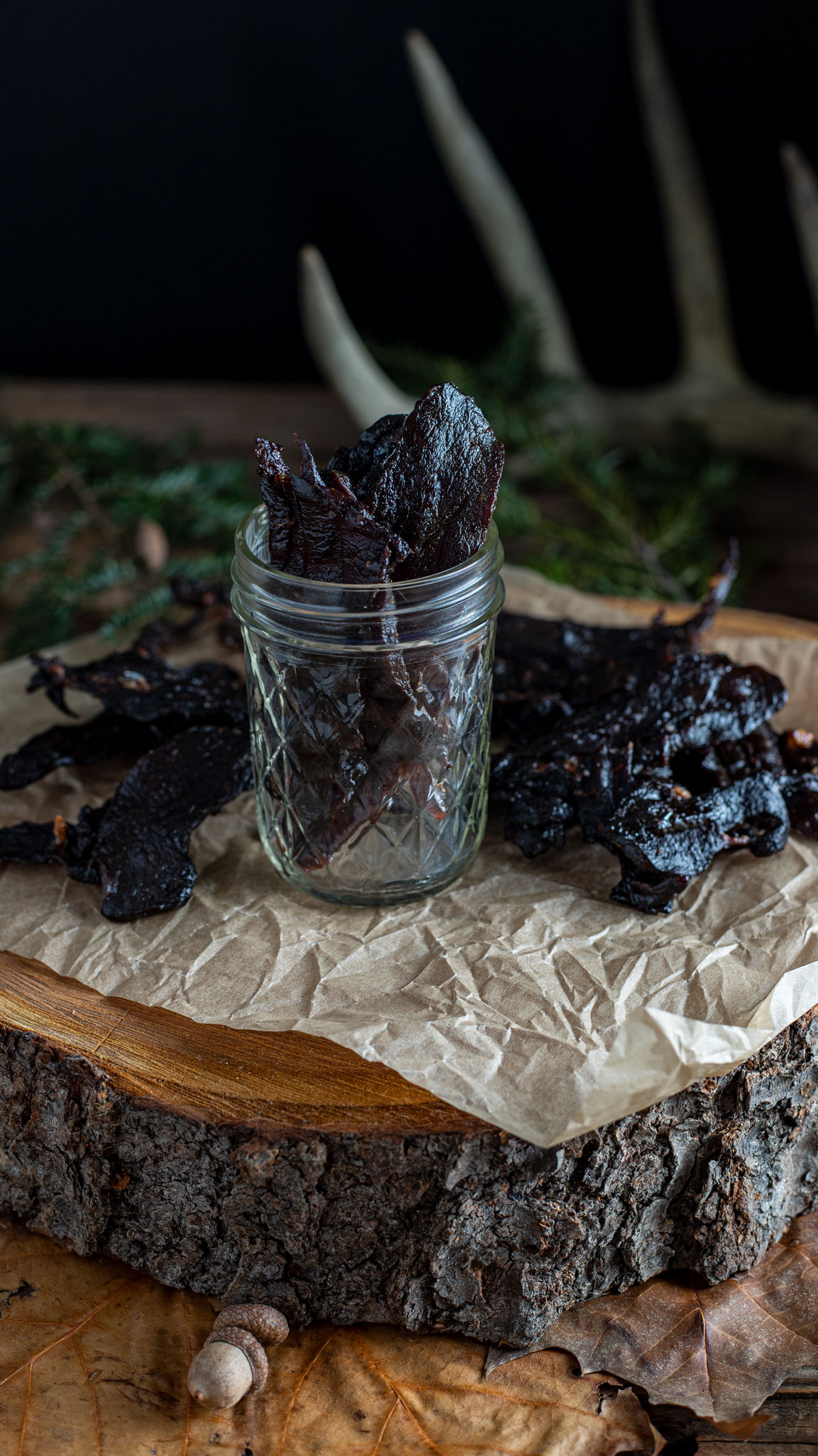 Jerky in jar in woodland scene.