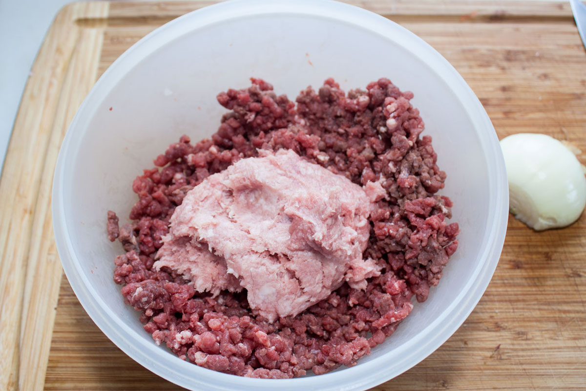 Ground beef and pork in a large bowl.